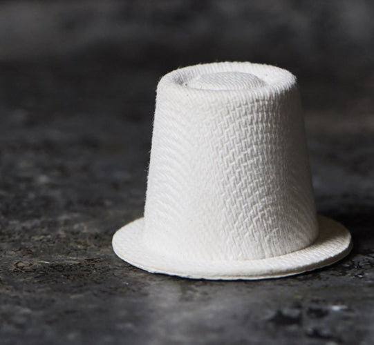 a white Ola home compostable coffee capsule sitting on top of a counter 