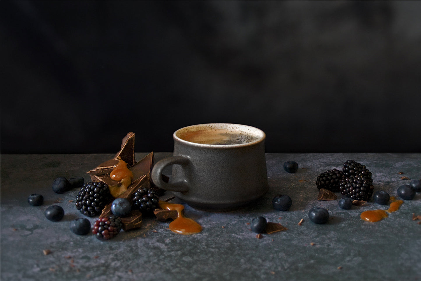 a cup of Ola coffee sitting on top of a table 